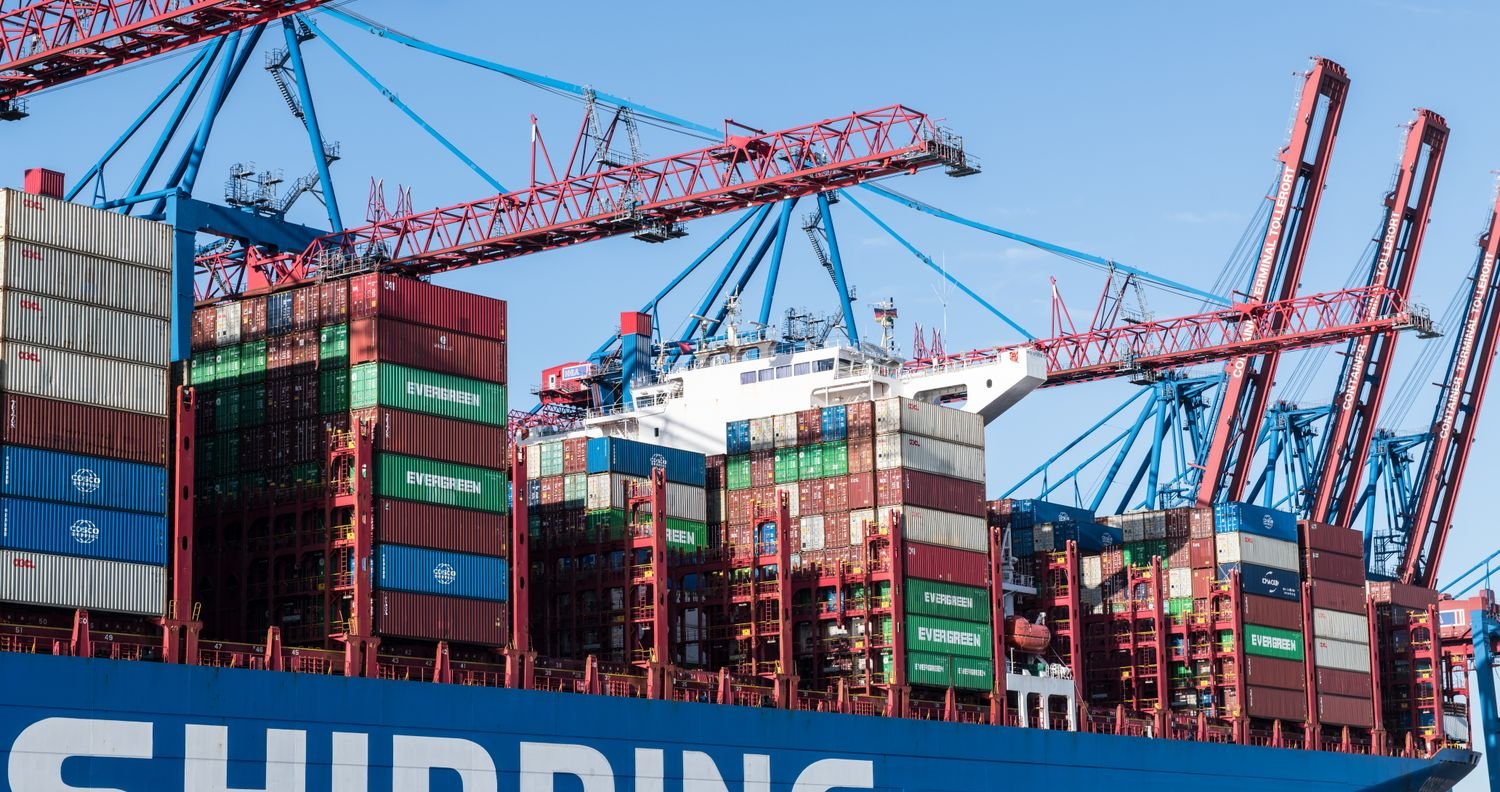 Container ship being worked by gantry cranes at a shipping port